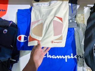 hand holding champion tshirt