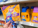 hand holding arm & hammer pacs in walgreens