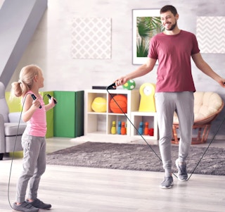 a father and daughter jumping rope