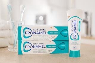 Sensodyne Pronamel on counter next to toothbrushes