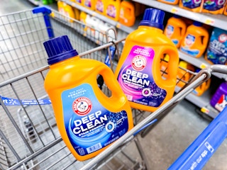 bottles of arm and hammer detergent in a shopping cart at walmart