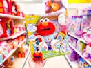 hand holding a learning elmo plush in a target toy aisle