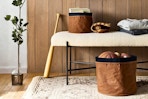 Lifestyle image of Studio McGee Canvas Storage Baskets in home setting used to store sports equipment