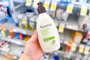 person holding a bottle of aveeno lotion