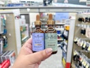 hand holding sheamoisture hair oil in walgreens