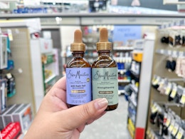 hand holding sheamoisture hair oil in walgreens