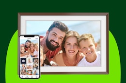 A 10.1-inch Wi-Fi photo picture frame with a smiling family in the picture. A smartphone holding the photos is next to it.