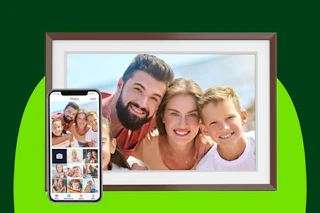A 10.1-inch Wi-Fi photo picture frame with a smiling family in the picture. A smartphone holding the photos is next to it.