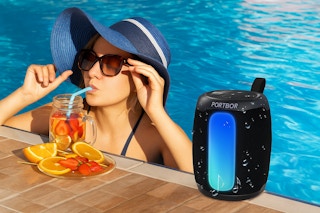 a woman next to a bluetooth speaker