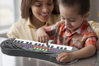 mother and child playing with piano keyboard