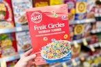 hand holding nice fruit circles cereal in walgreens