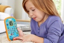 a girl playing with a vtech bluey phone toy
