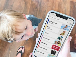 a person on a cellphone with clearance with a little boy looking up towards the food
