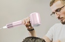 a person using a hair dryer on someone's hair