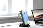 a phone on a wireless charger next to a laptop