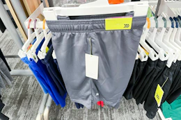 hand holding an all in motion kids' shorts at target