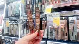 hand holding loreal faux brow pens in walgreens