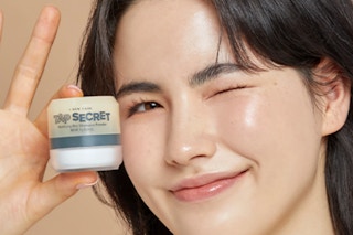 a woman holding a jar on dry shampoo