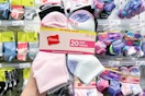 hand holding 20 pairs of hanes kids' socks at target