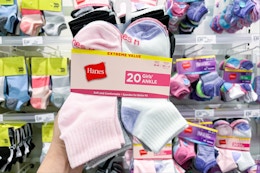 hand holding 20 pairs of hanes kids' socks at target