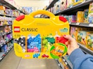 hand holding lego-suitcase in walmart aisle
