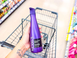 hand holding nexxus shampoo in walgreens