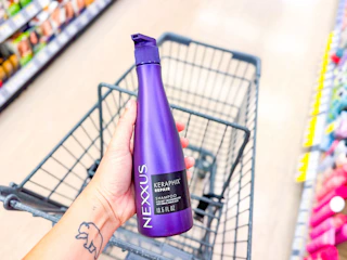 hand holding nexxus shampoo in walgreens