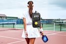 Lifestyle image of the EYCI Pickleball set being carried by a woman on a tennis ball court