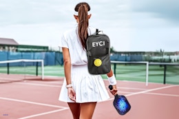 Lifestyle image of the EYCI Pickleball set being carried by a woman on a tennis ball court