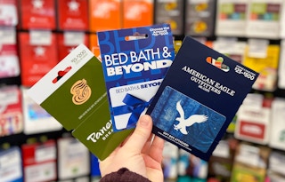 someone holding panera, bed bath and beyond and american eagle gift cards at cvs