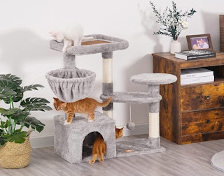 a grey cat tree with cats on it