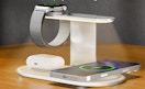 an iPhone, watch, and AirPods on a charging stataion