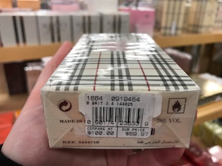 A box of perfume, with a compare at and our price tag on side.