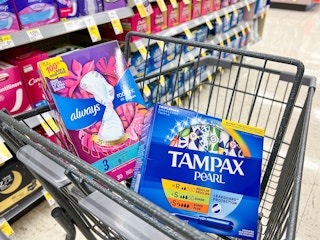 angled shot of shopping cart with tampons and pads