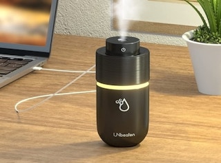 Black humidifier on a wooden table