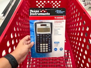 hand holding a texas instruments scientific calculator at target