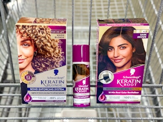 two boxes of schwarzkopf hair color and root spray in walmart cart