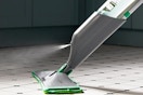 a spray mop on a floor
