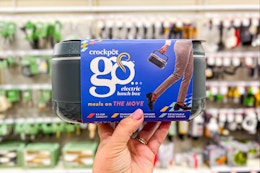 hand holding a crock-pot lunch box at target