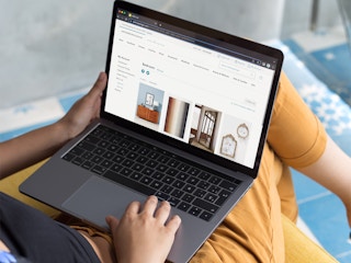 Someone looking at their Anthropologie wishlist on a laptop