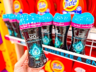 hand holding a bottle of downy unstopables at target