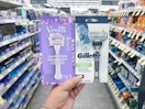 hand holding gillette and venus razors in walgreens 