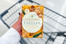 person holding a pack of yardley bar soap over a cart
