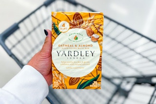 person holding a pack of yardley bar soap over a cart