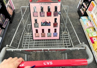 cosmetic gift set in cvs cart with hand on handle