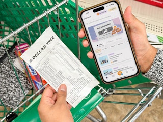 a person holding an iphone with a coupon app in the dollar tree store