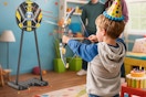 a boy using a bow and arrow toy set