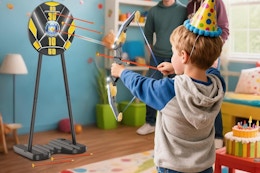 a boy using a bow and arrow toy set
