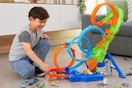 child playing with a Hot Wheels track