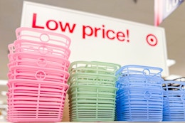 Three colors (pink, green & blue) Brighroom jelly baskets in Target store on shelf with "Low price!" sign in background